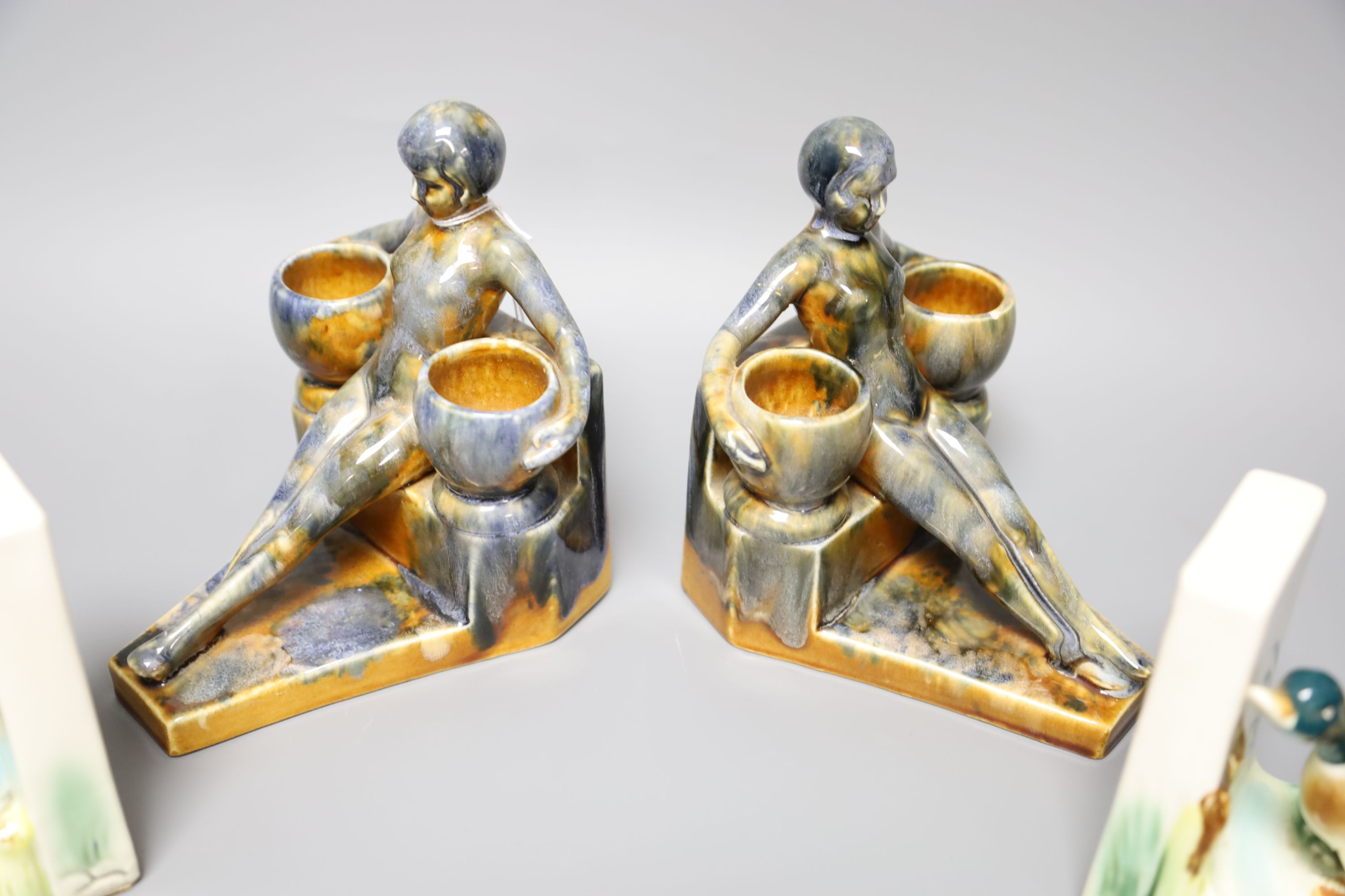 A Moorcroft green ground 'Columbine' pattern bowl, Dia 11cm and two pairs of ceramic bookends,